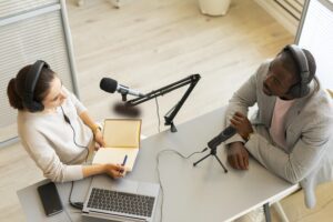 A woman and a man having a conversation about podcasting