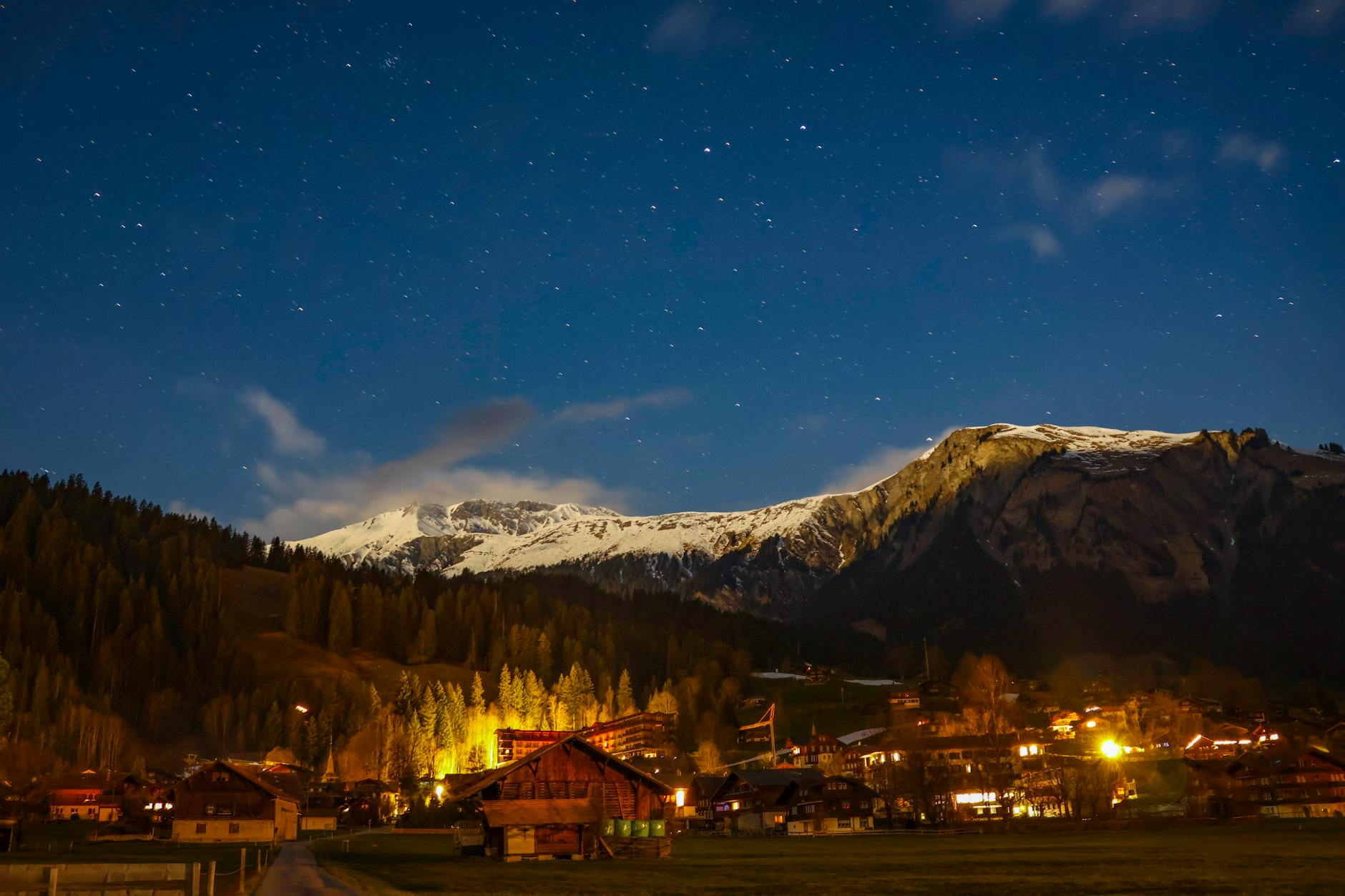 a night scene with a mountain range and a town